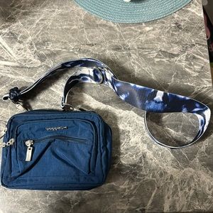 Dark blue Baggallini small crossbody about 8” width and 6” in height.